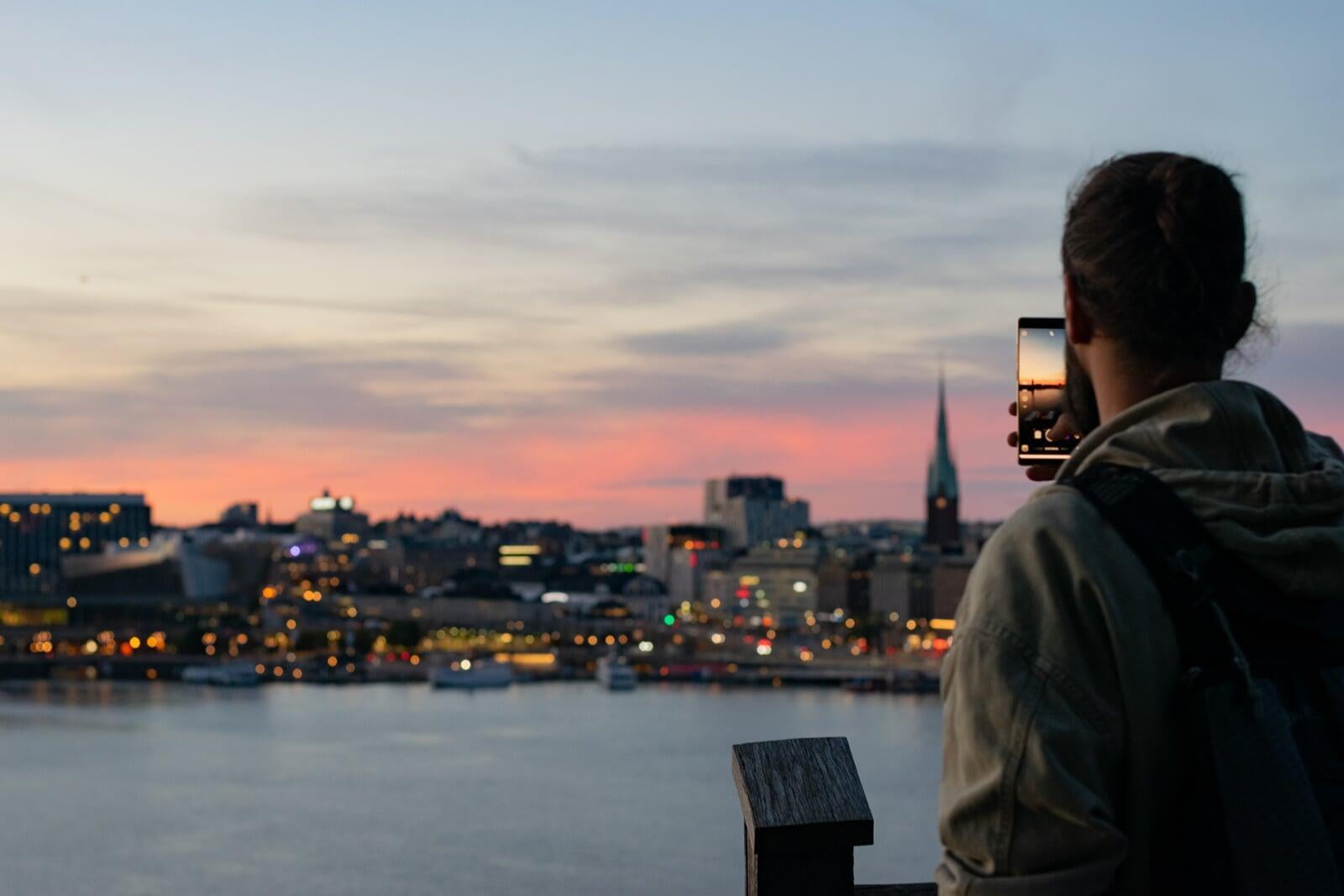 Man looking at city sunset